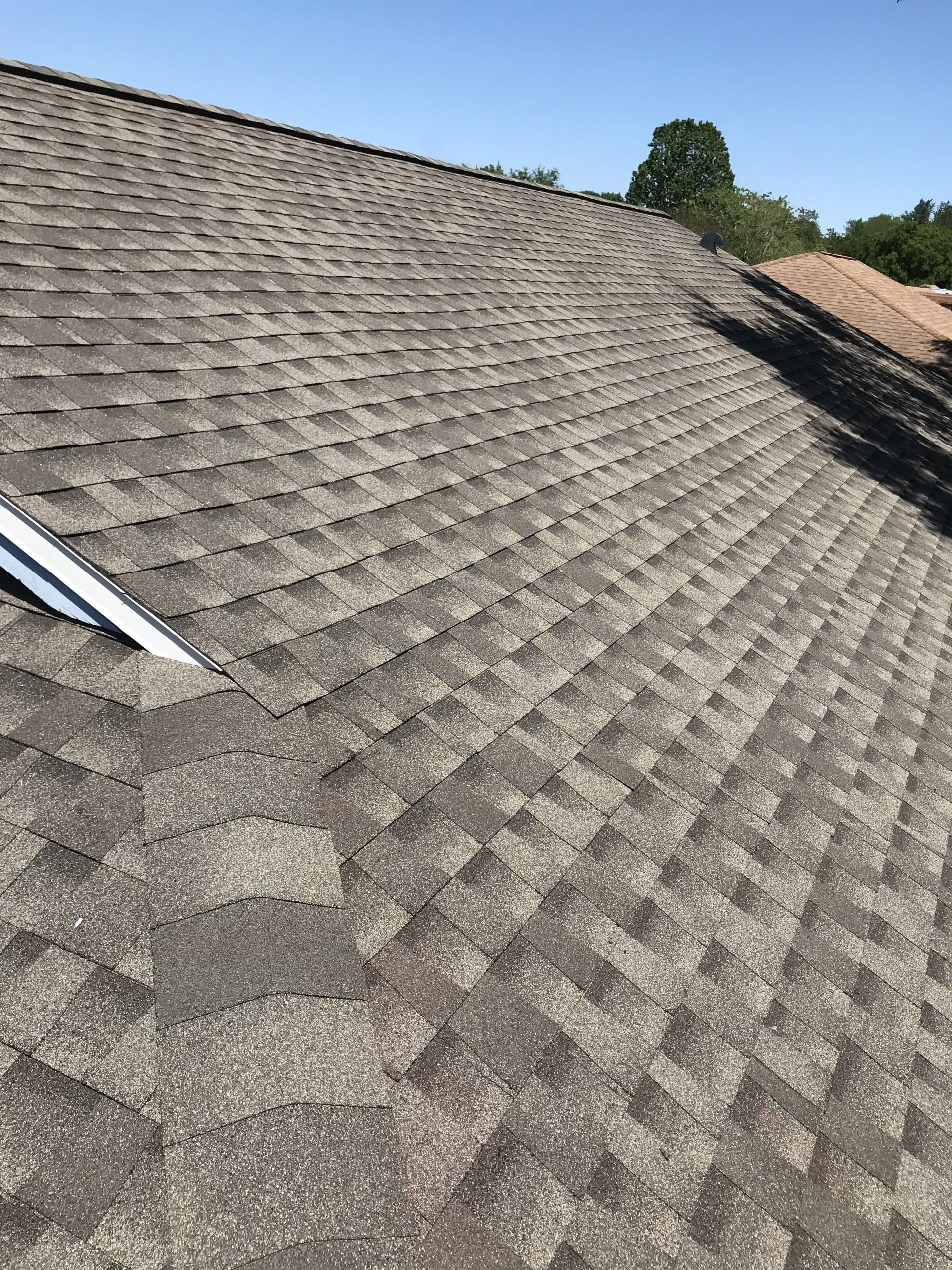 A close up of a roof with a blue sky in the background.