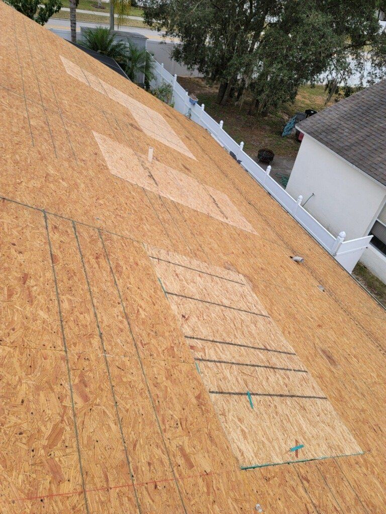 A roof with a few pieces of plywood on it