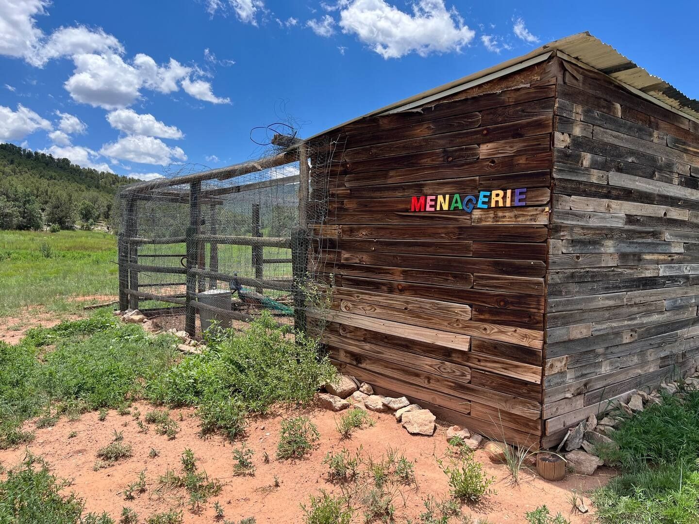 Wooden building with a wire enclosure,