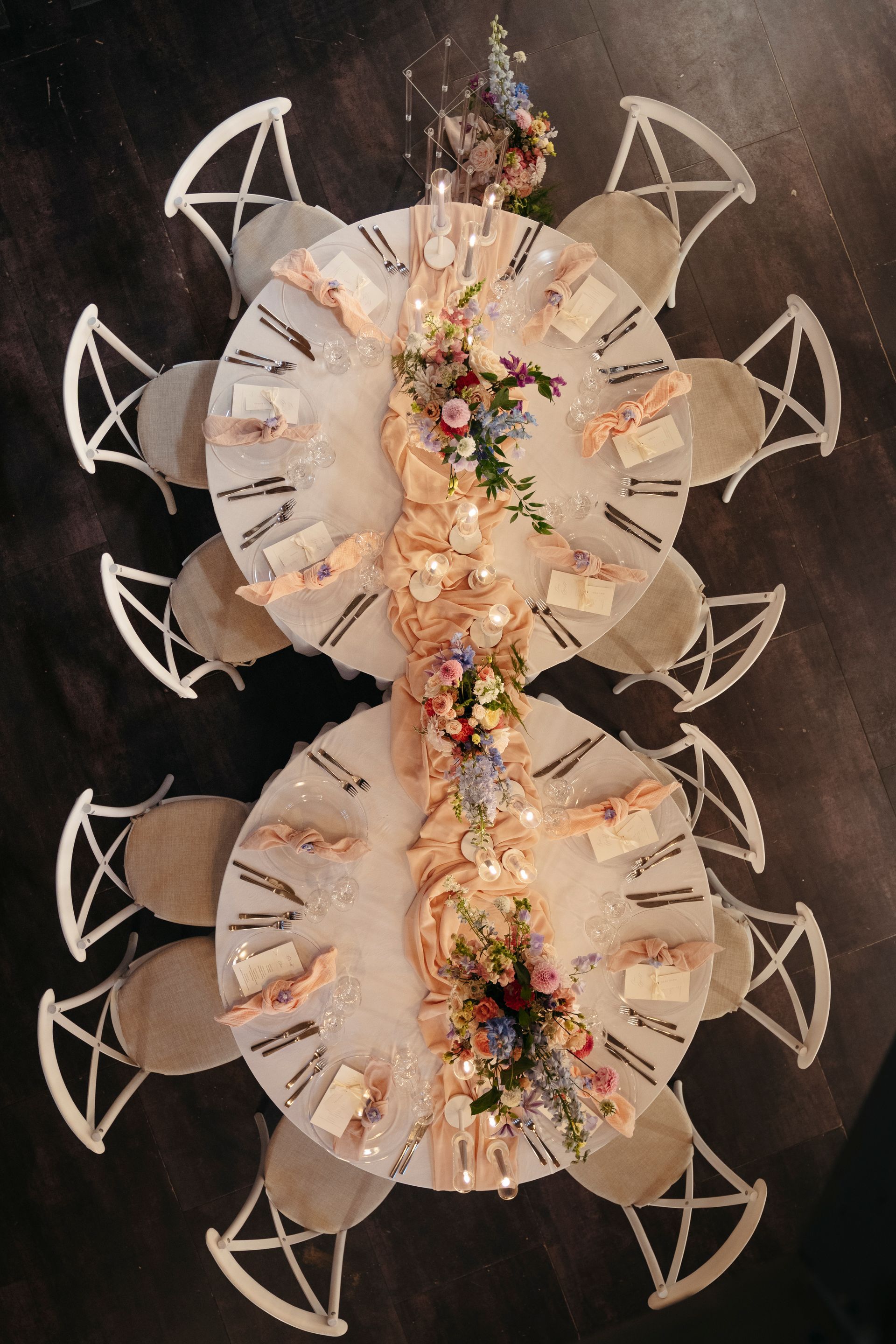 An aerial view of a table and chairs set for a wedding reception.