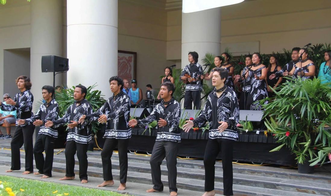 A group of people are standing in a line on a stage.