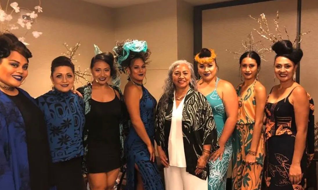 A group of women are standing next to each other in a room.