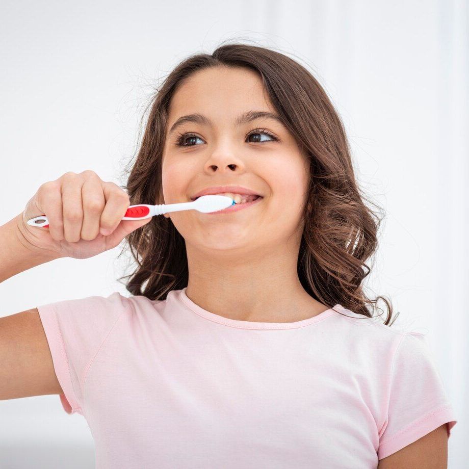 girl brushing her teeth