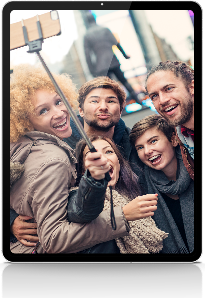 A group of people are taking a selfie on a tablet.