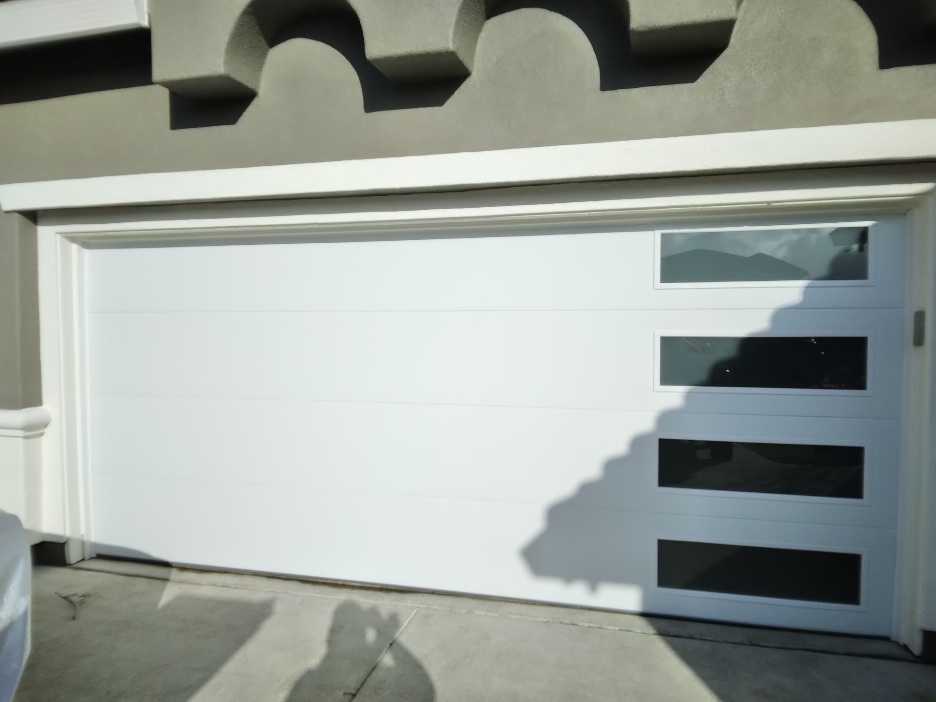 A white garage door with black stripes on it