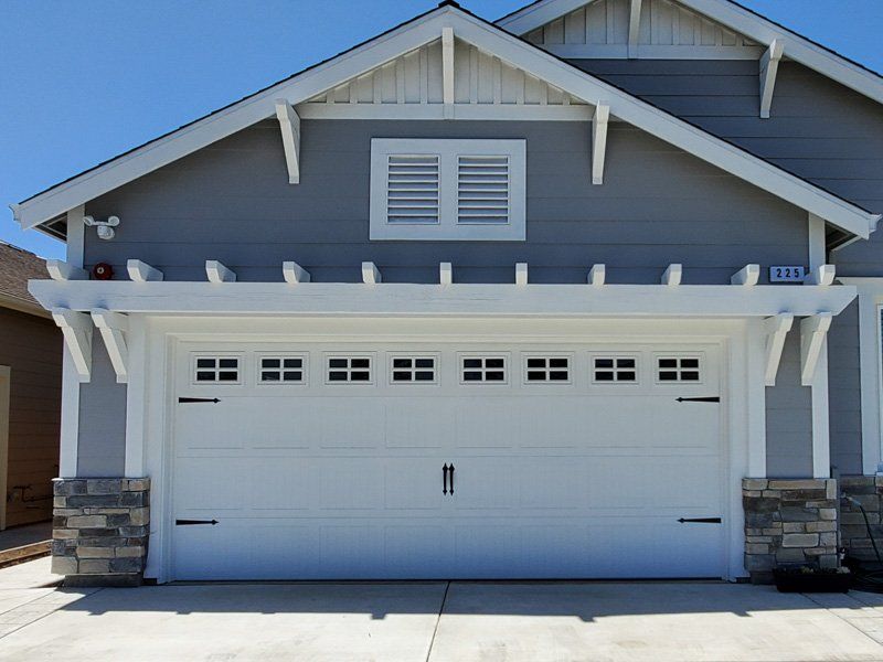 A gray house with a white garage door