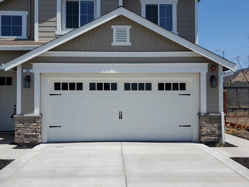 The front of a house with a white garage door