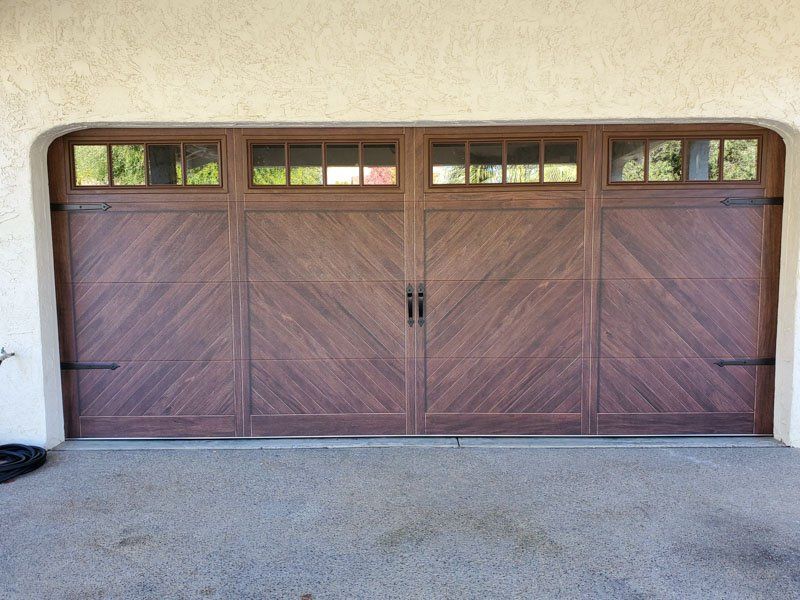A large wooden garage door with a chevron pattern