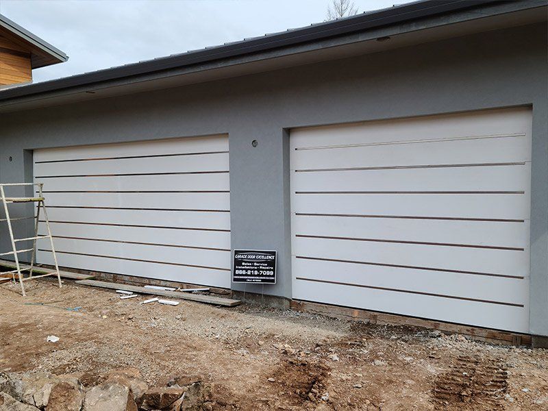 A garage door is being installed on the side of a building.
