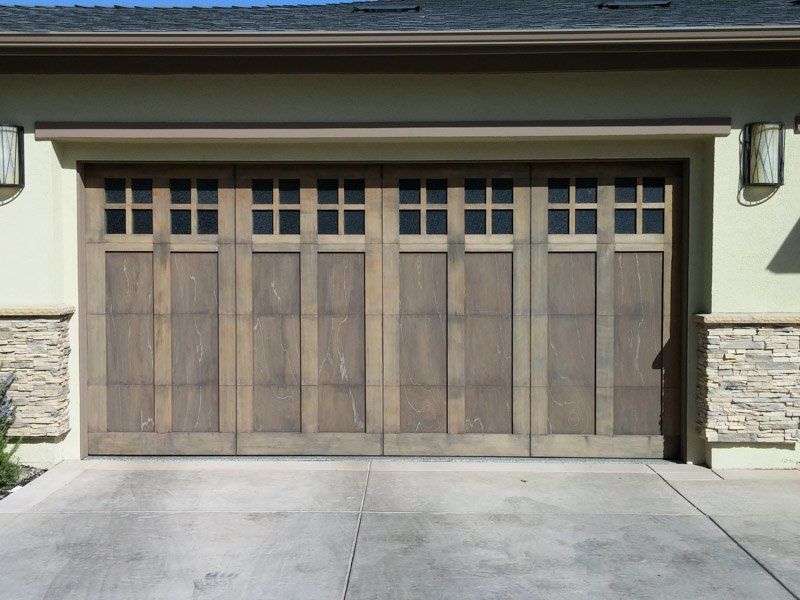 The garage door is made of wood and has a lot of windows