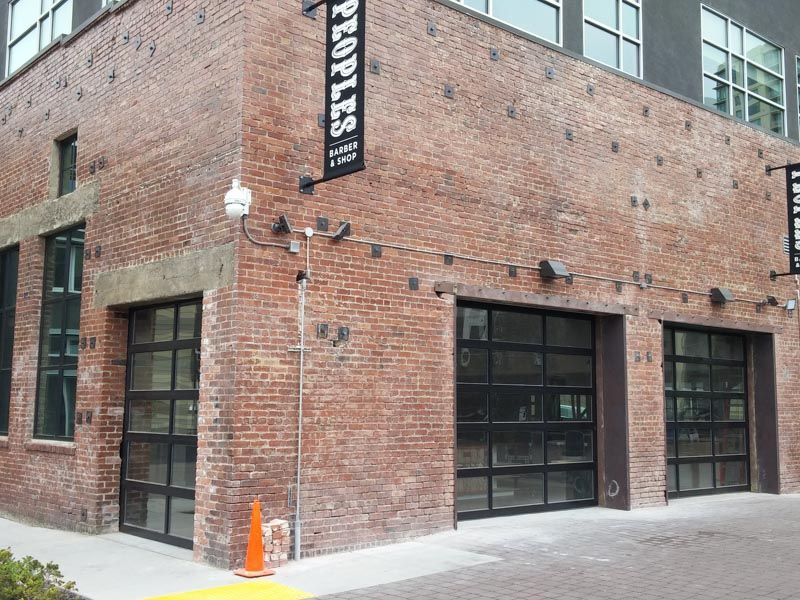 A brick building with a sign that says peoples on it