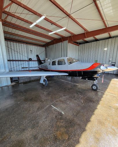 A small plane is parked in a hangar.