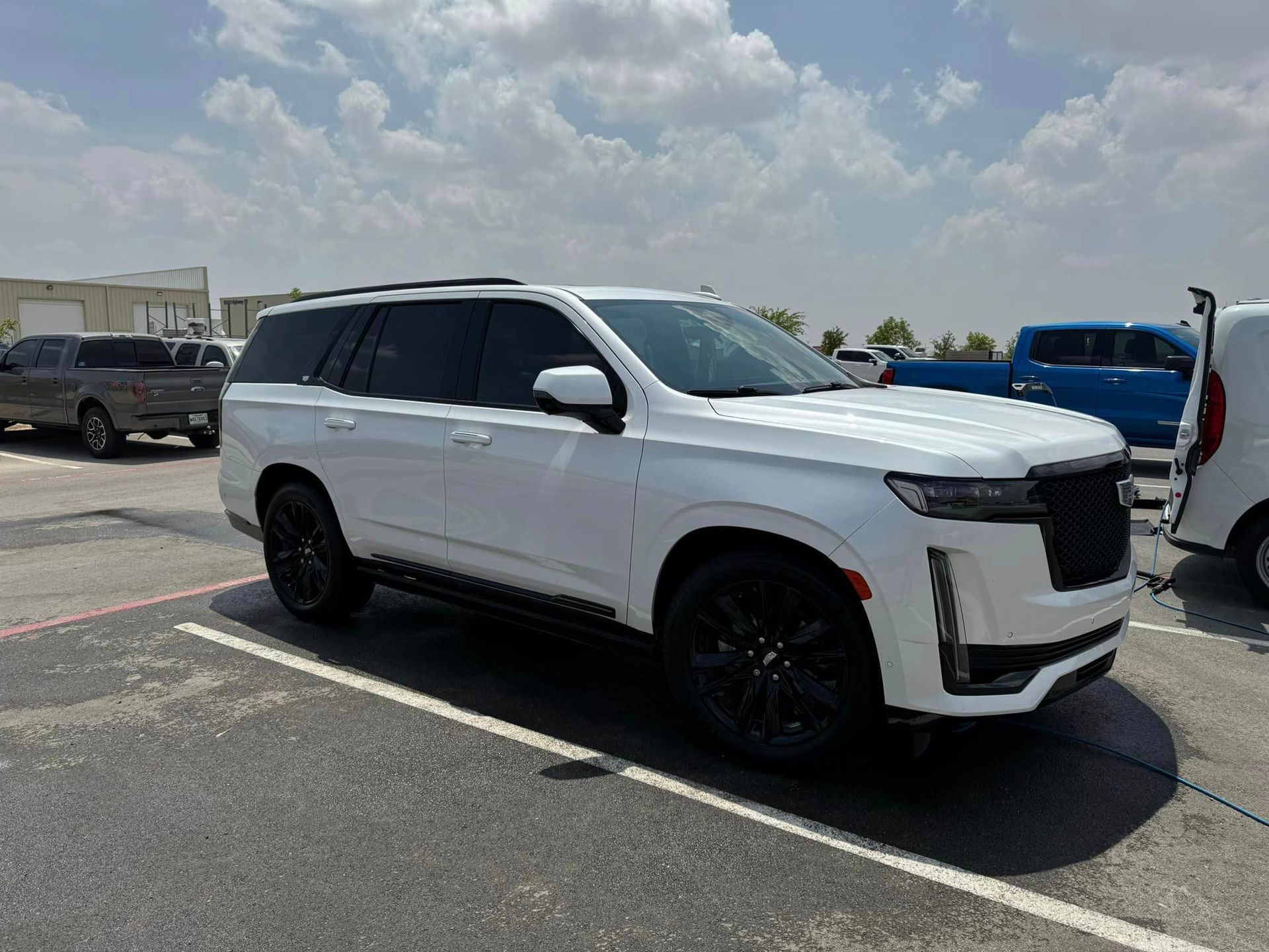 A white suv is parked in a parking lot.