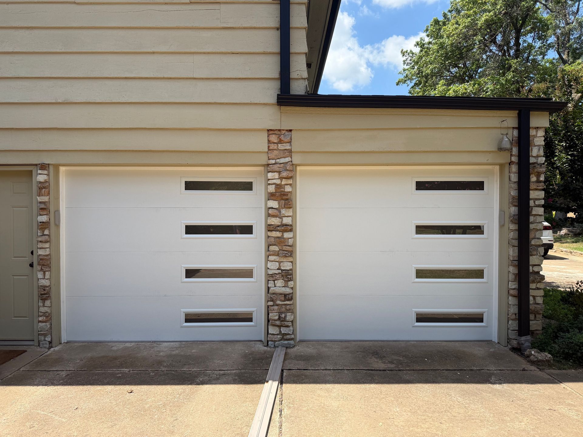 Two garage doors installed by Norman Garage Door. Two garage doors installed by Norman Garage Door.