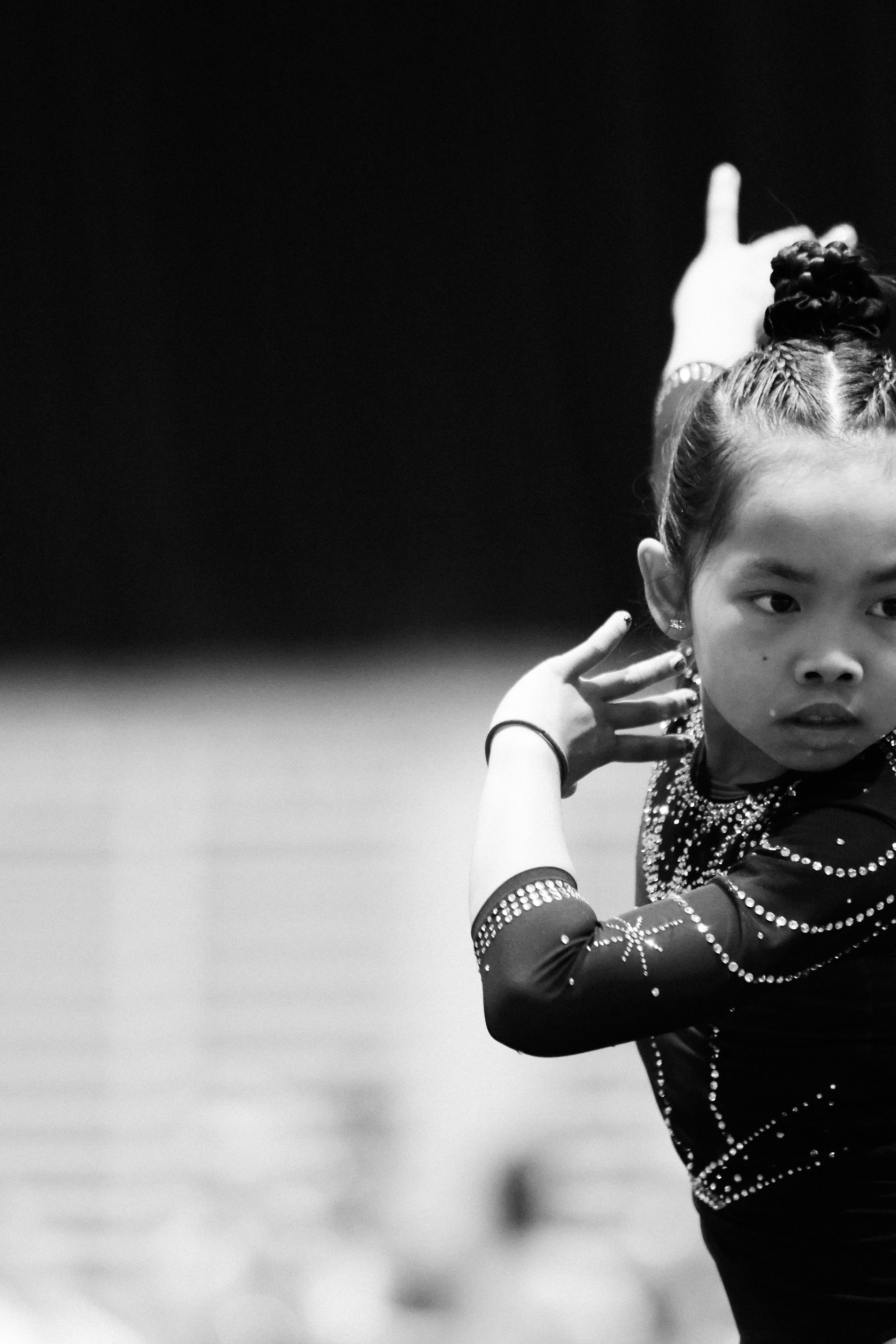 A black and white photo of a young girl doing gymnastics
