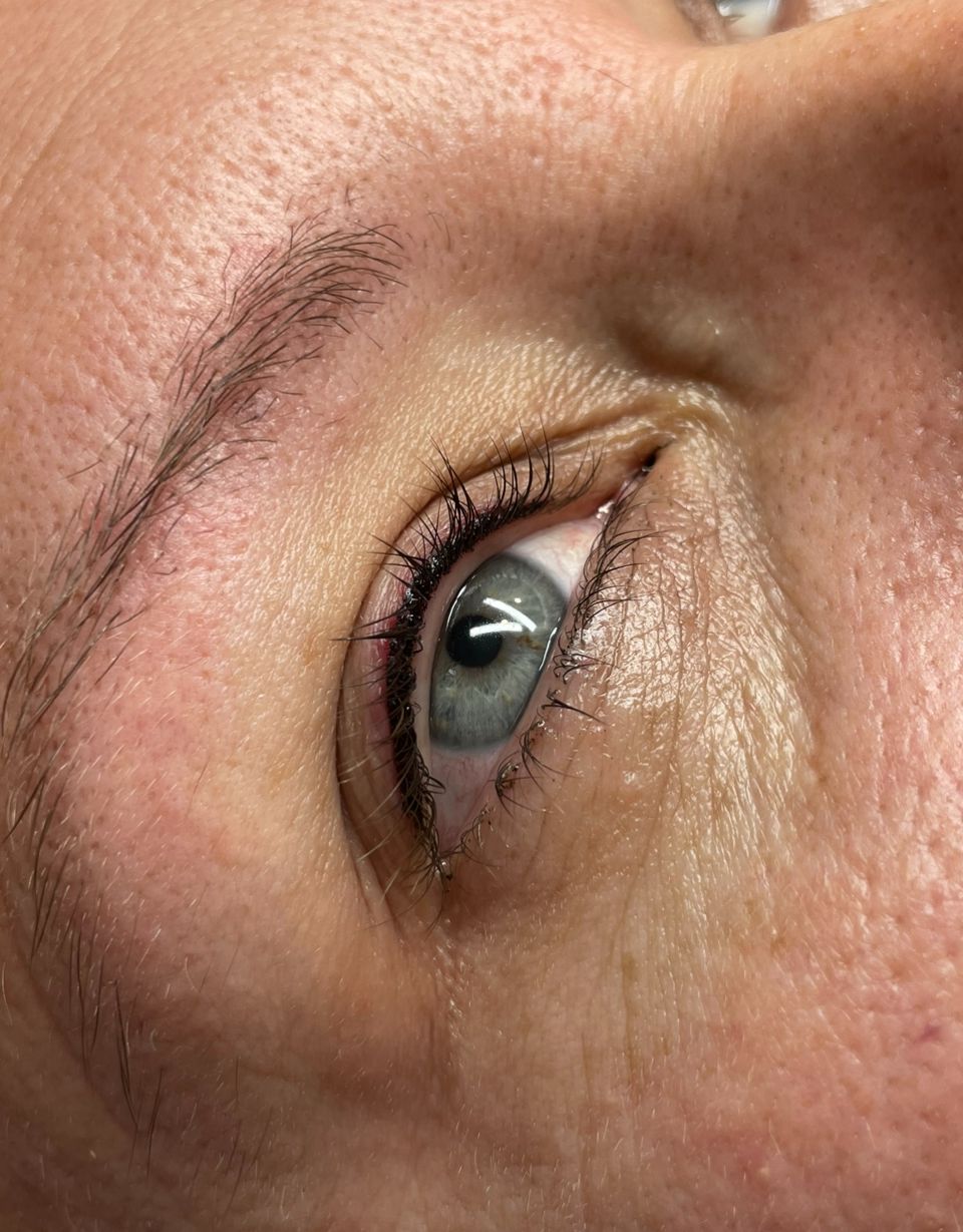 a close up of a woman 's eye with mascara on it .