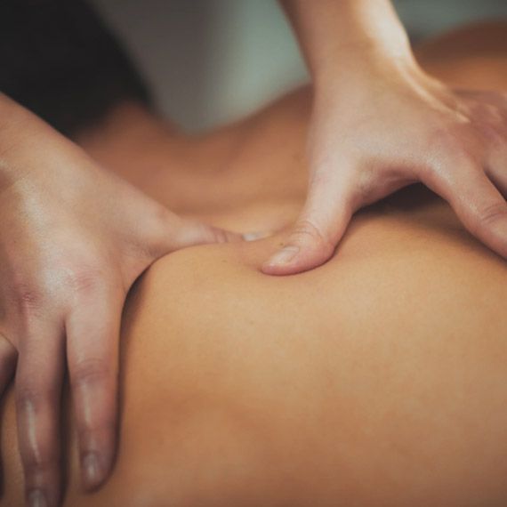 A close up of a person getting a massage on their back.