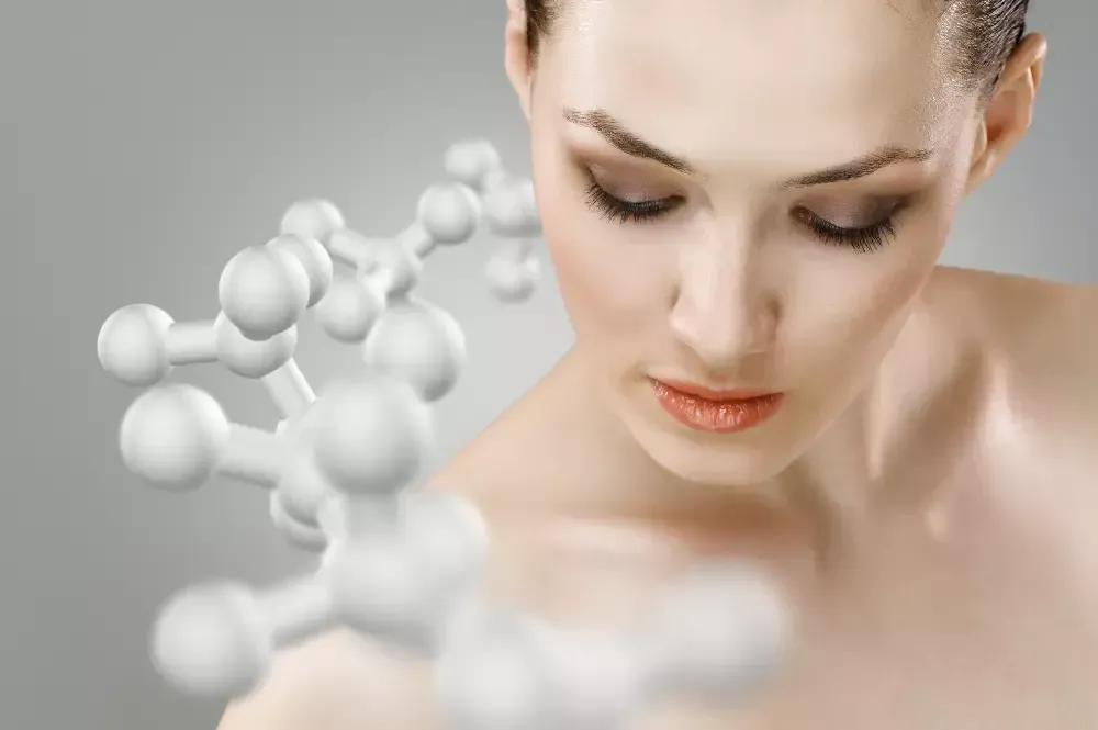 A close up of a woman 's face with a molecule in the background.