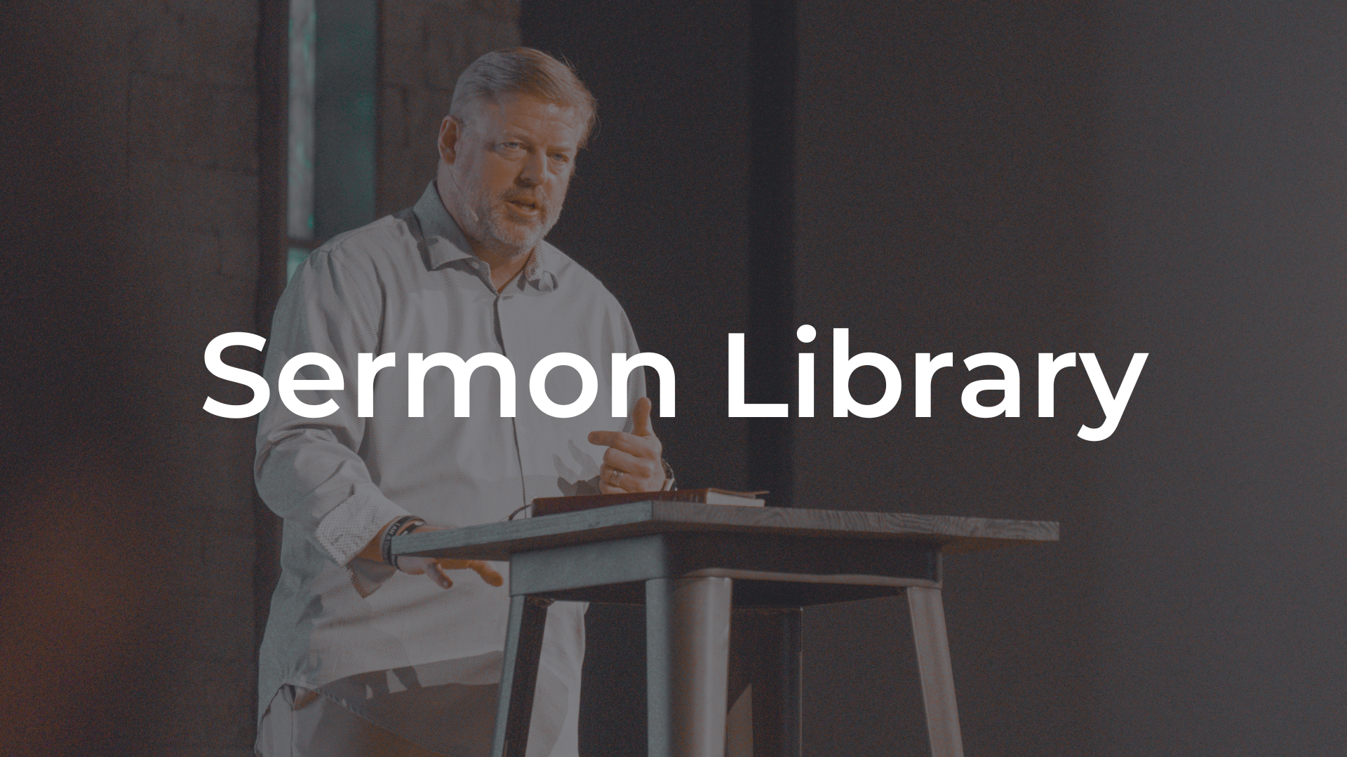 A man is standing at a podium giving a sermon.