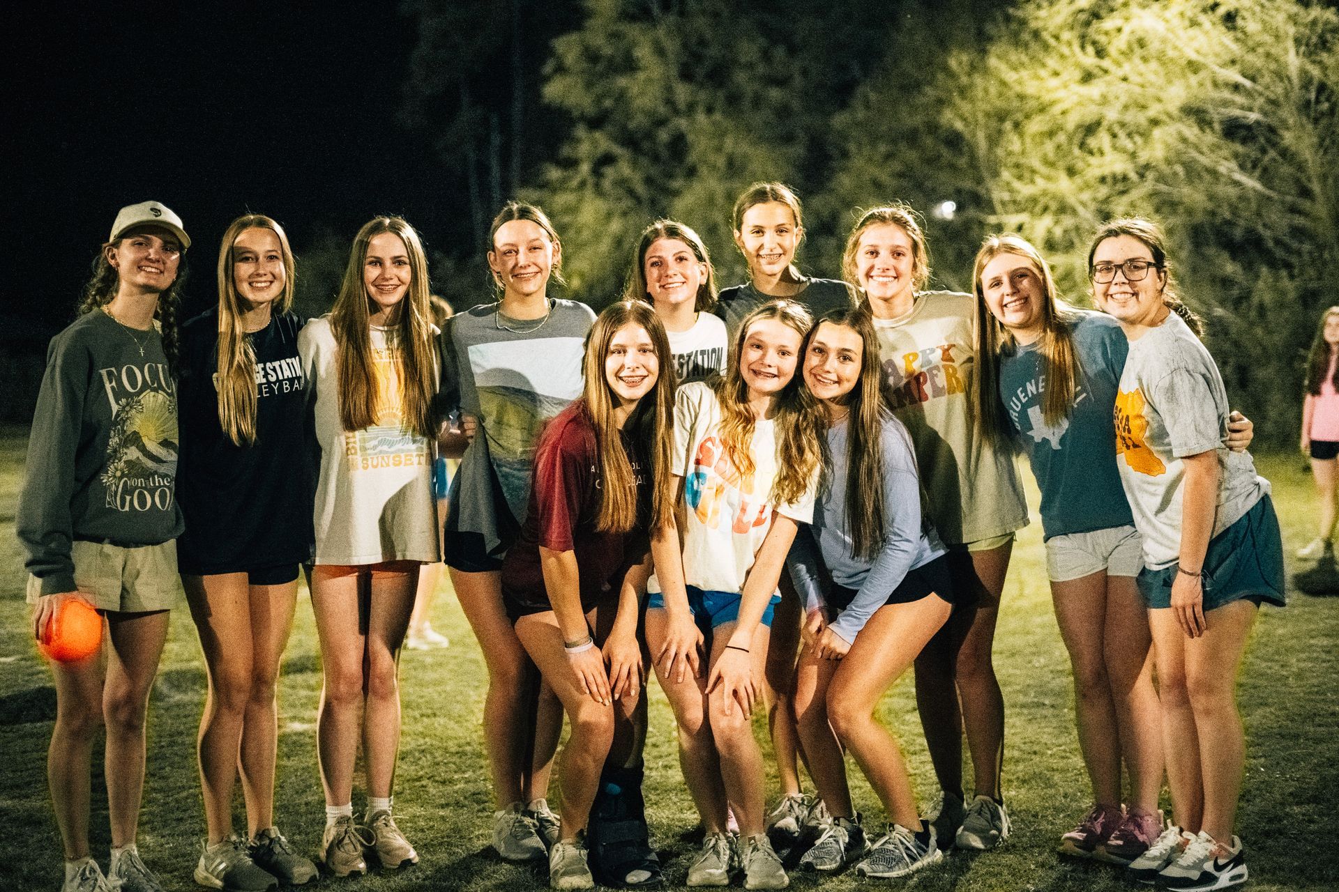A group of young women are posing for a picture together.