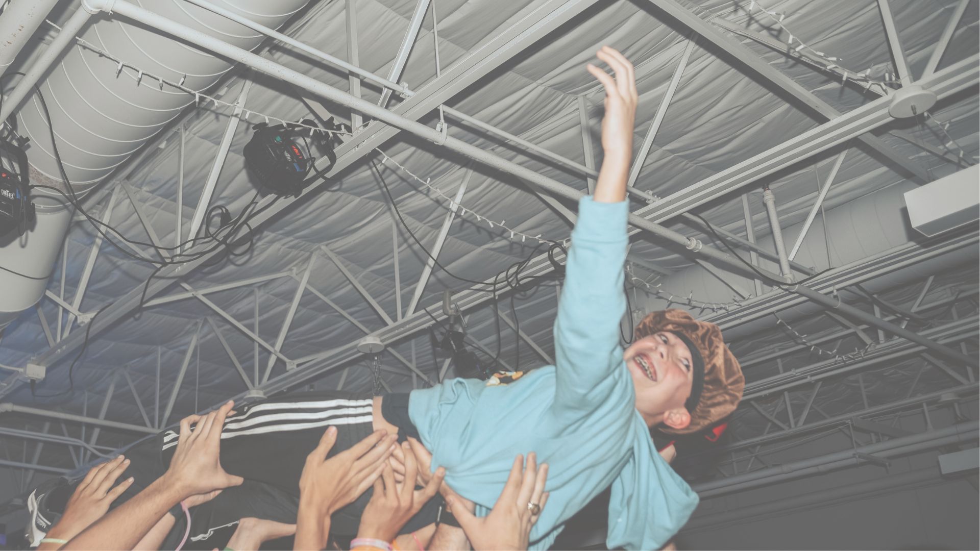 A person is being lifted in the air by a crowd of people.