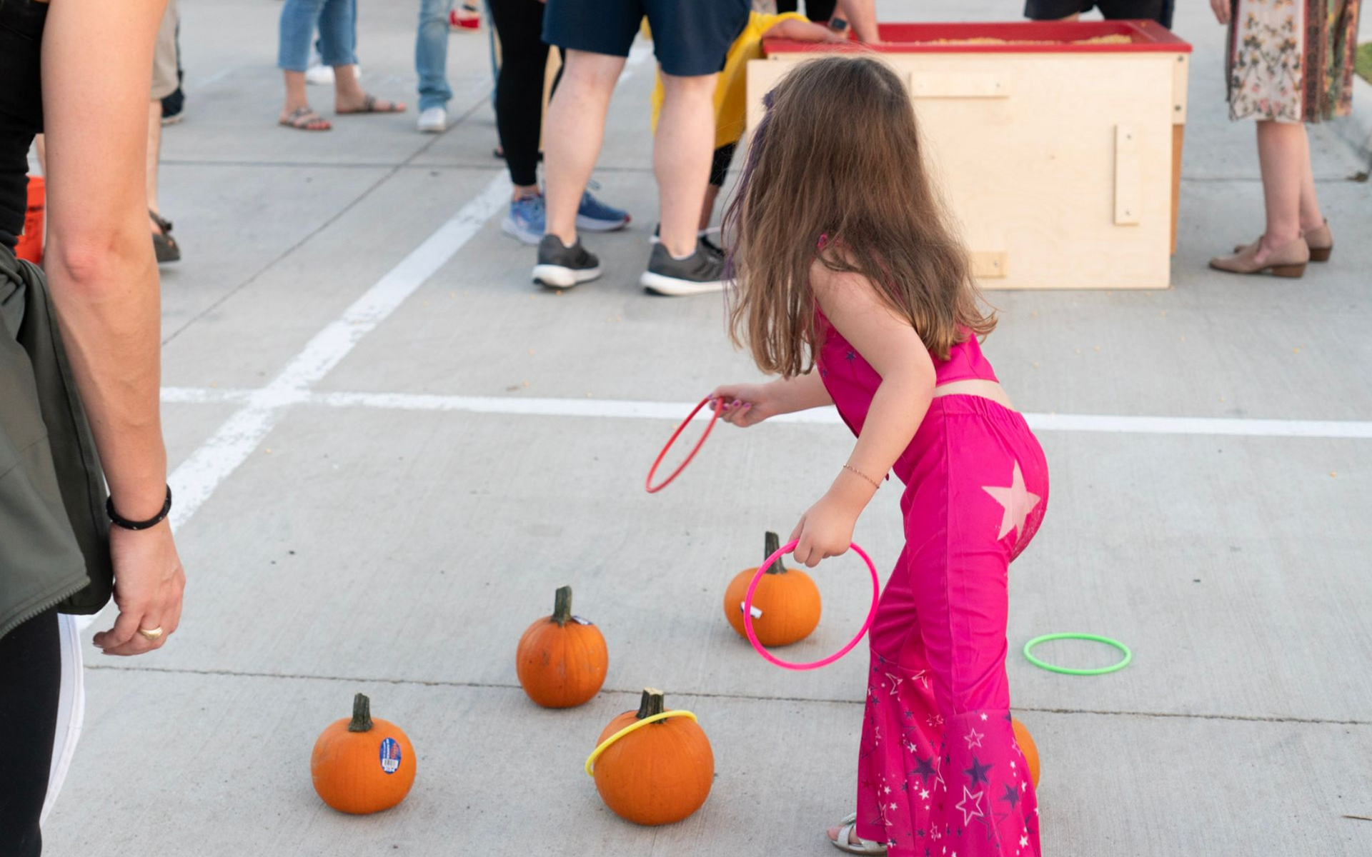  playing ring toss with pumpkins outdoor event. Fall FEstival at Christ Church in College Station TX