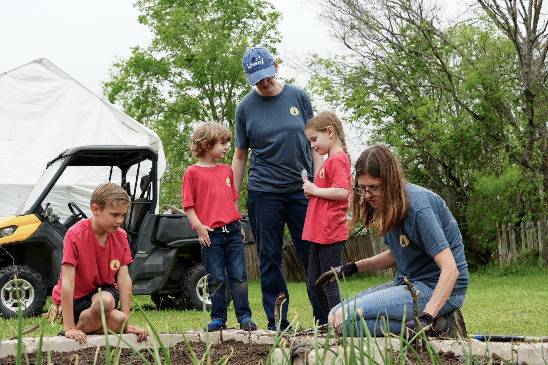 A group of people are working in a garden.