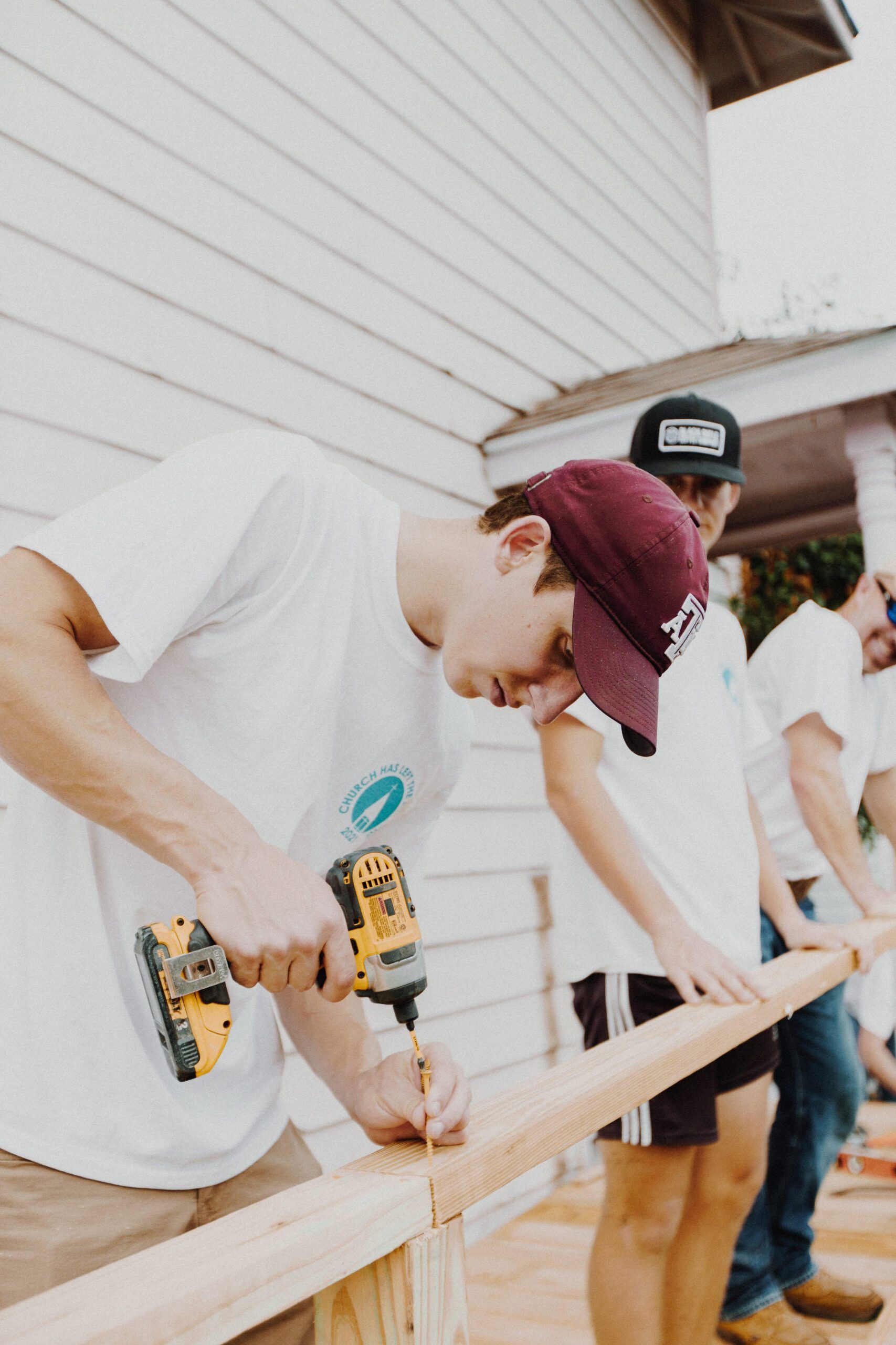 A group of young men are working on a wooden structure.