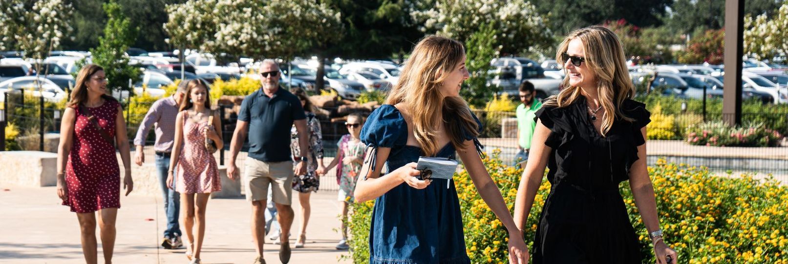 A group of people are walking down a sidewalk.