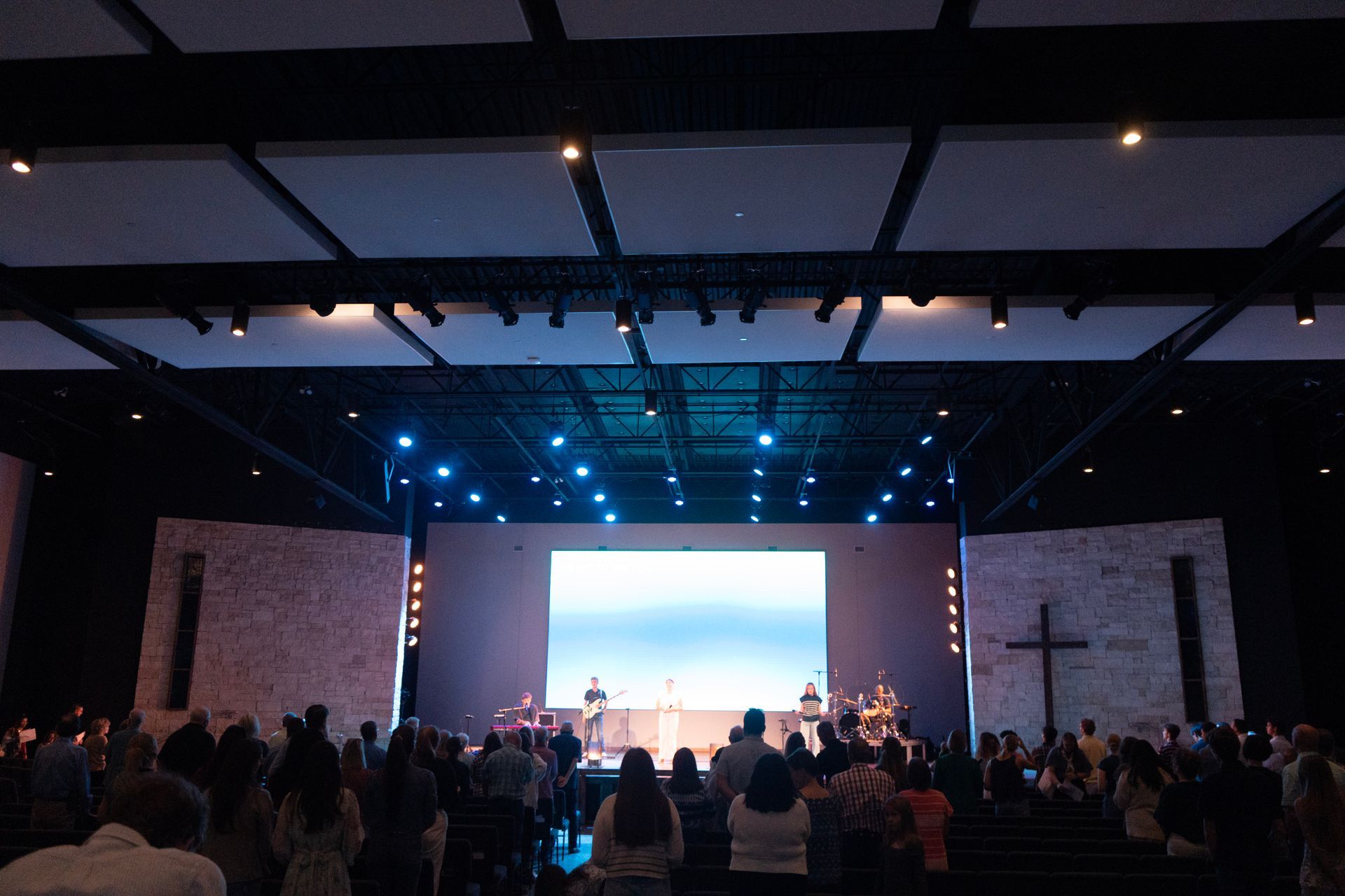 Church service in progress with worship, singing, teaching, prayer and community