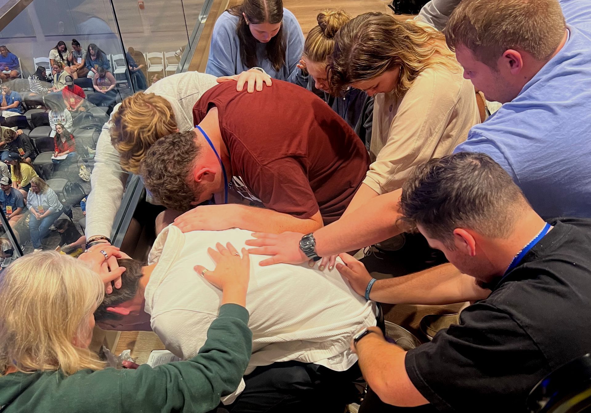 A group of people praying Christ Church in College Station TX