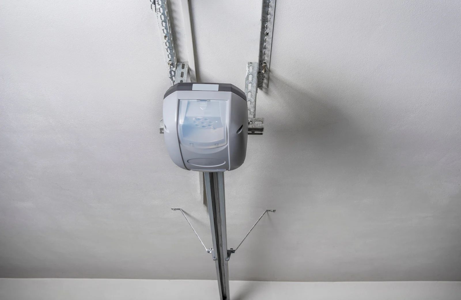 Garage door opener mounted on a white ceiling.