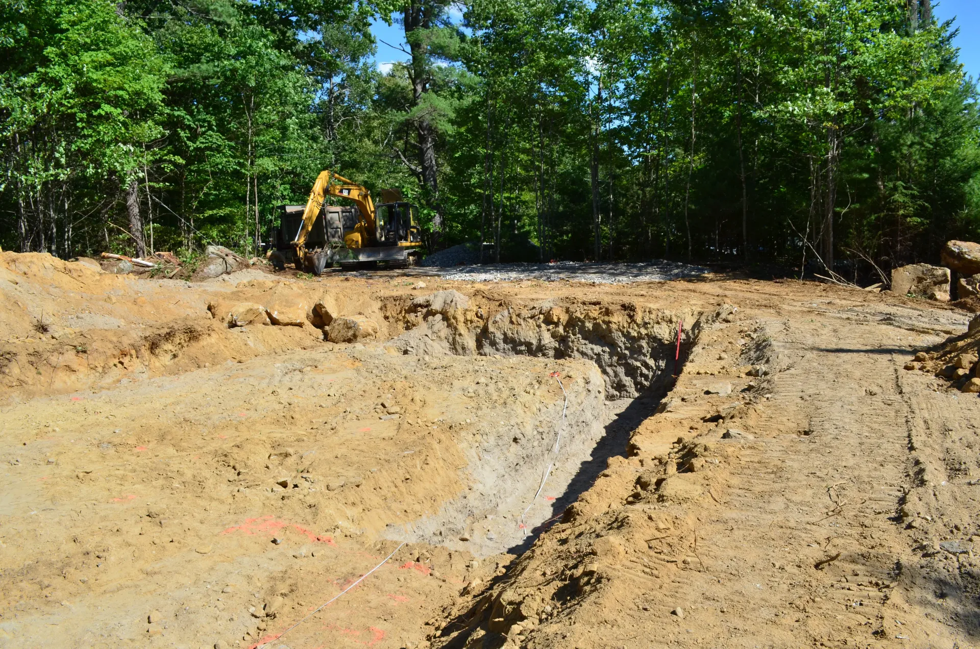 A bulldozer is digging a hole in the dirt in a field.