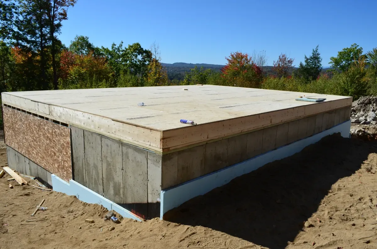 A large piece of wood is sitting on top of a pile of dirt.