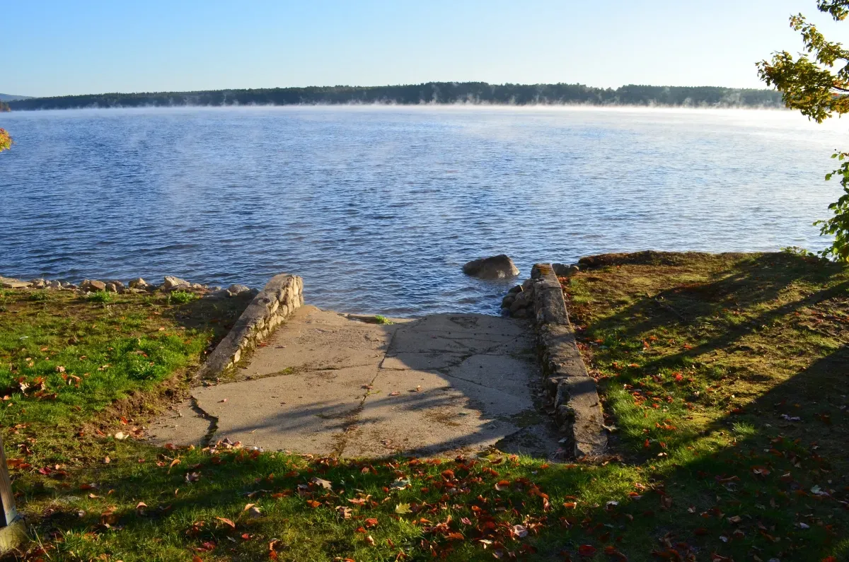 There is a concrete walkway leading to the water.
