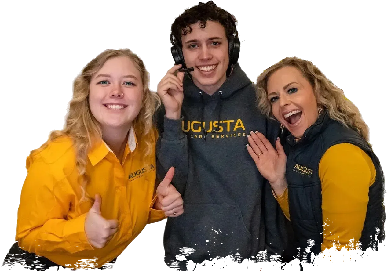 Three people smiling, wearing yellow and gray clothing, one with a headset and giving a thumbs up. Representing Command Center