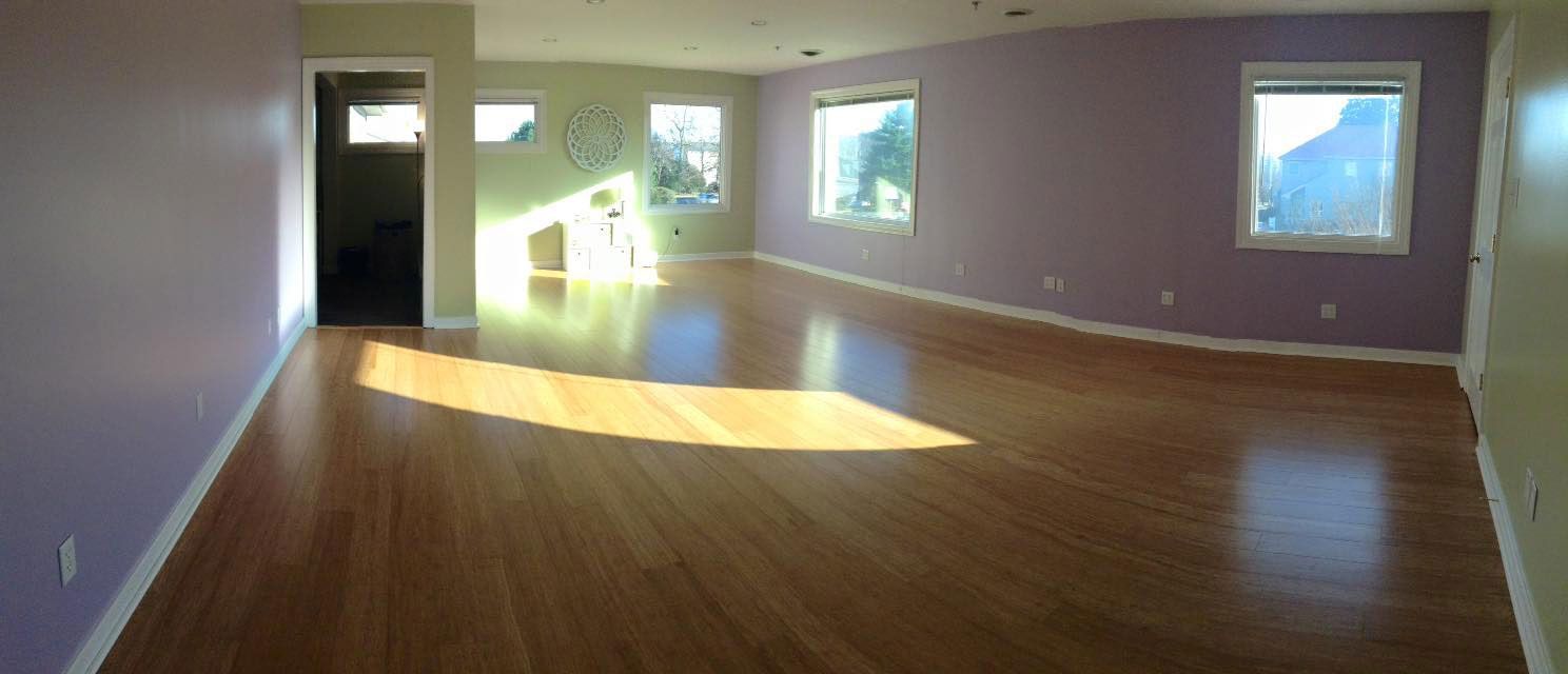 a room with a wood floor and a window with a wood floor