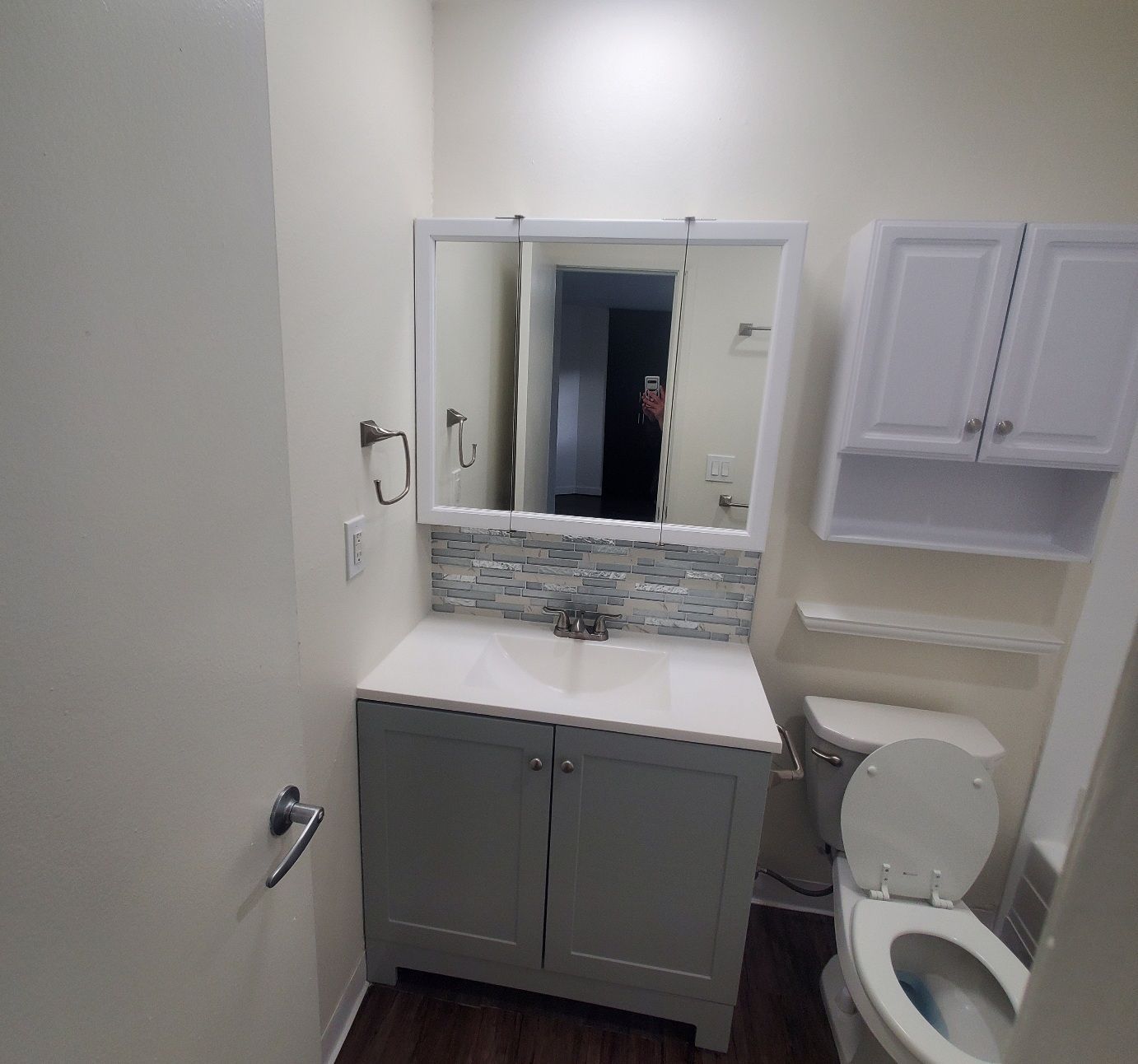 A bathroom with a sink , toilet and mirror