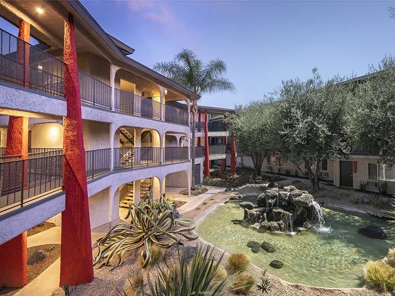 A large building with a waterfall in the middle of it