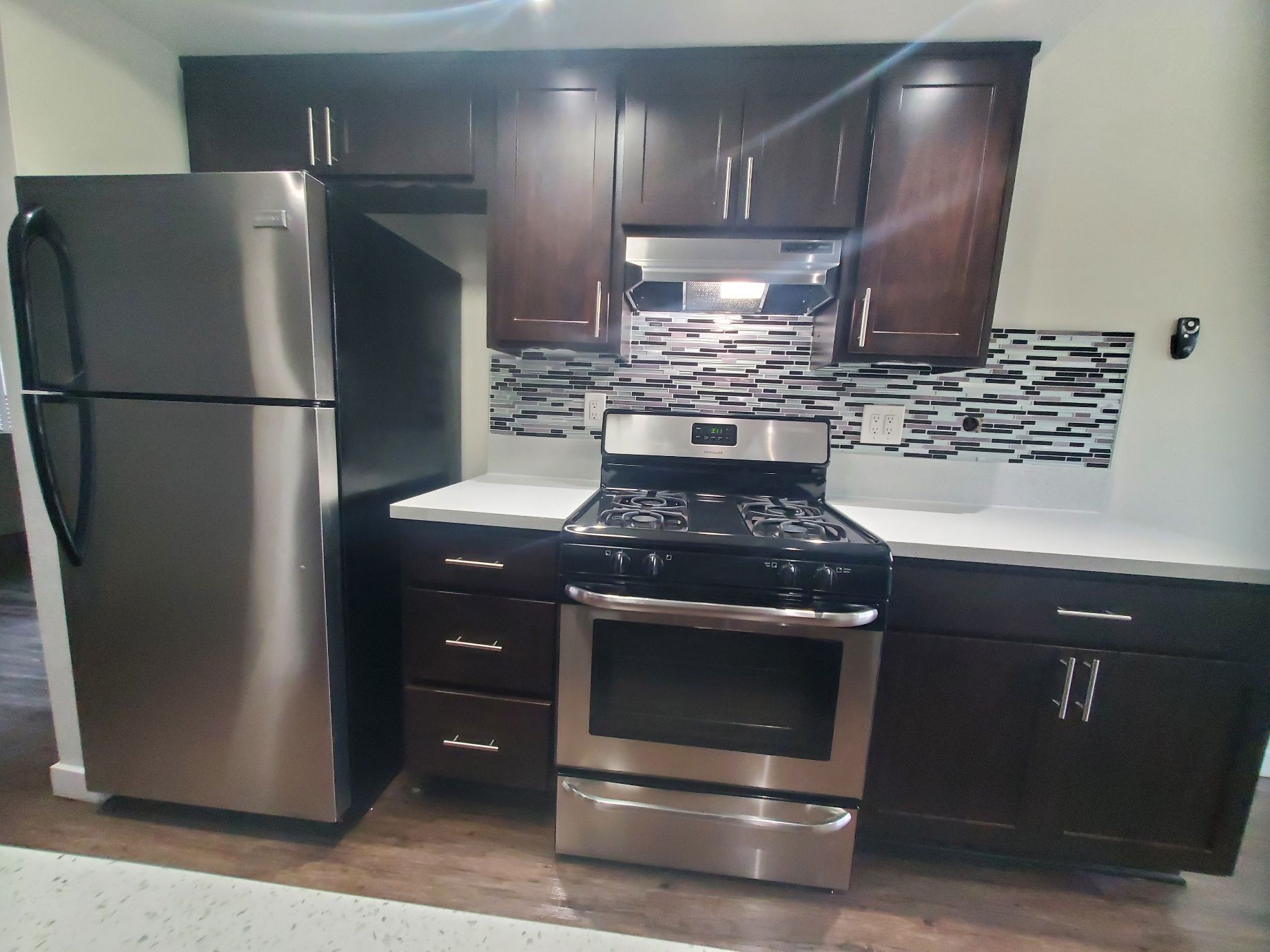 A kitchen with stainless steel appliances and wooden cabinets