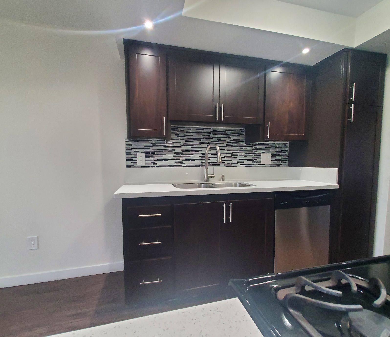 A kitchen with brown cabinets and stainless steel appliances