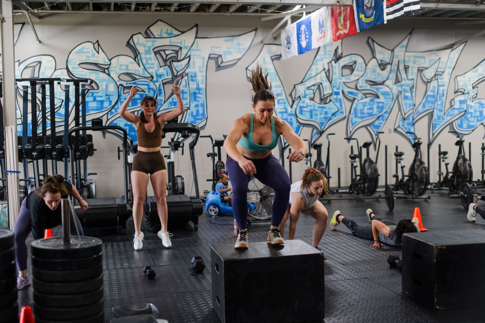 A group of women are doing exercises in a gym.