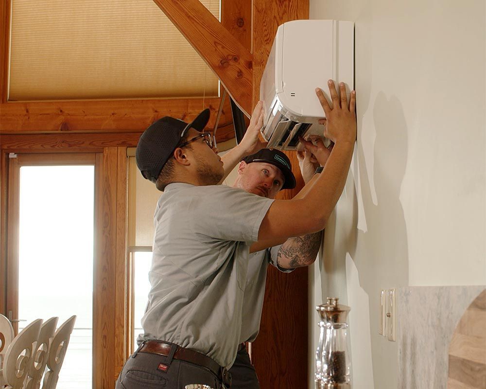 a white air conditioner is hanging from the ceiling in a room .