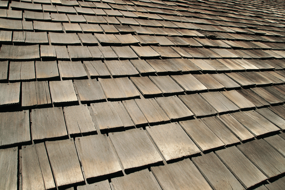 Close-up of weathered wooden roof shingles in warm sunlight