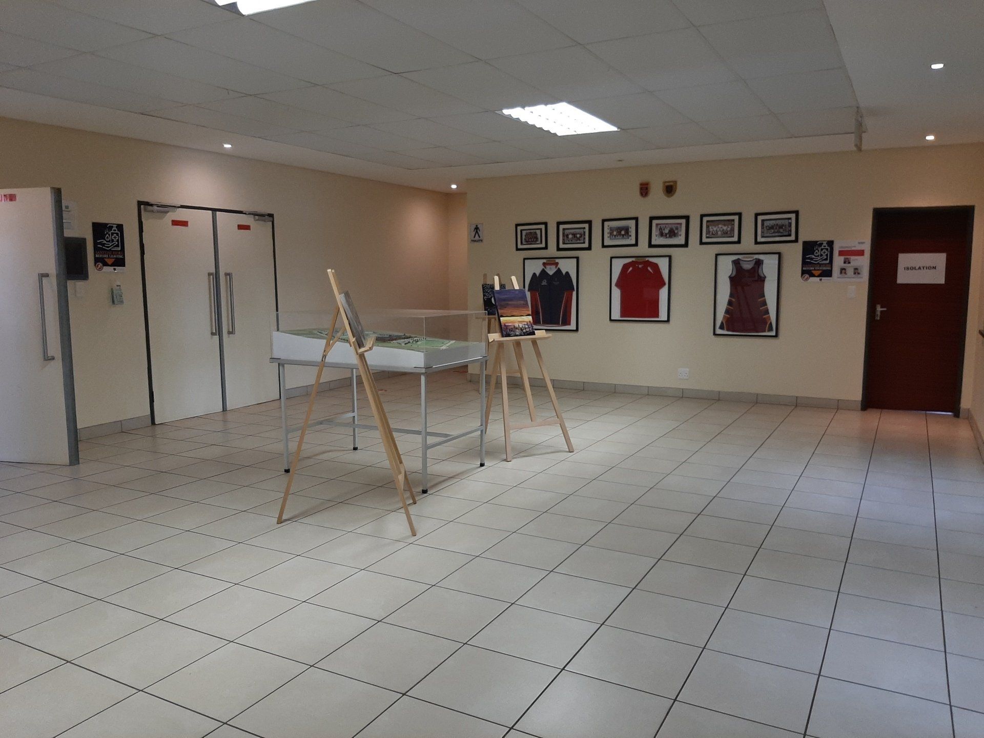 a room with a tiled floor and a few paintings on the wall