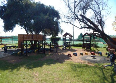a playground with a tree in the middle of it