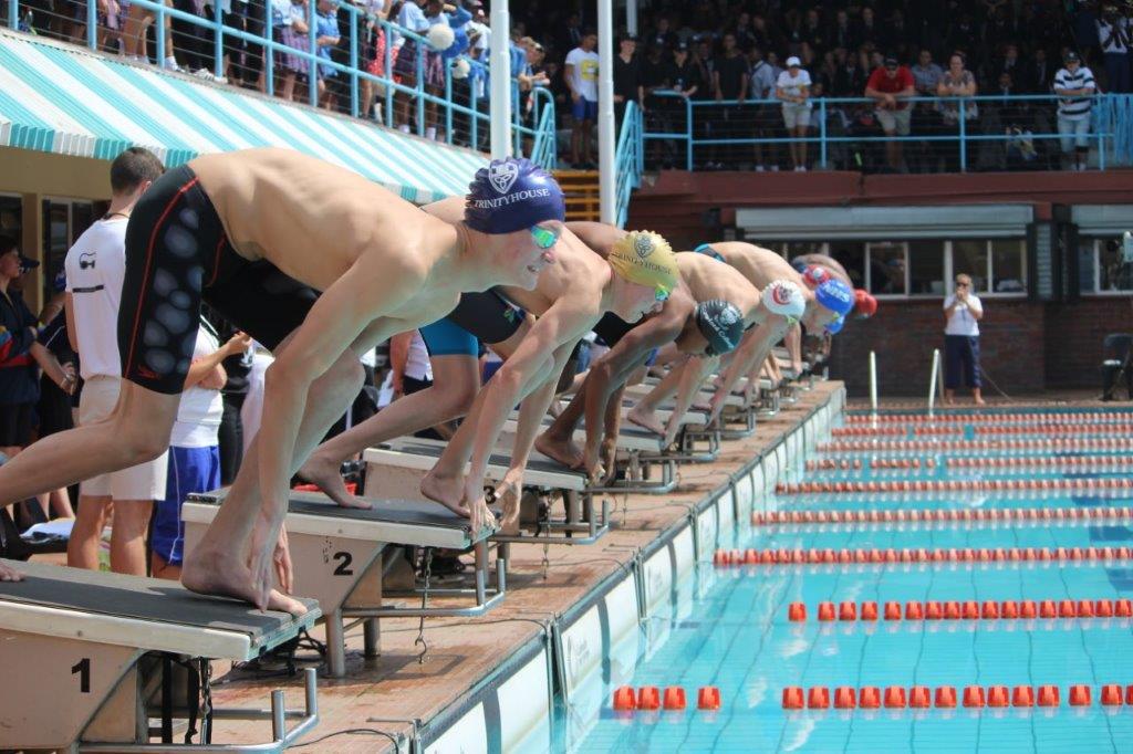 a group of swimmers are getting ready to swim in a pool