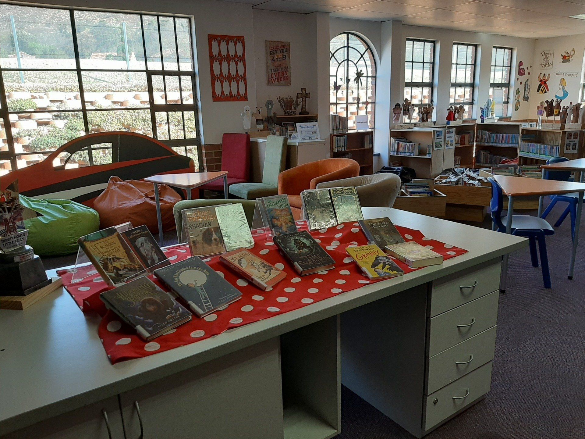 a row of books on a table in a library