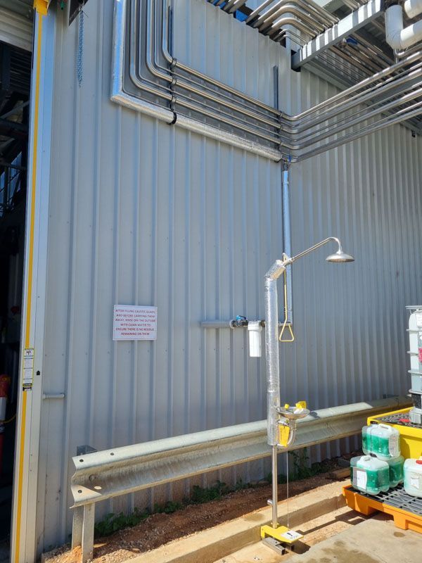There is a shower outside of a building.