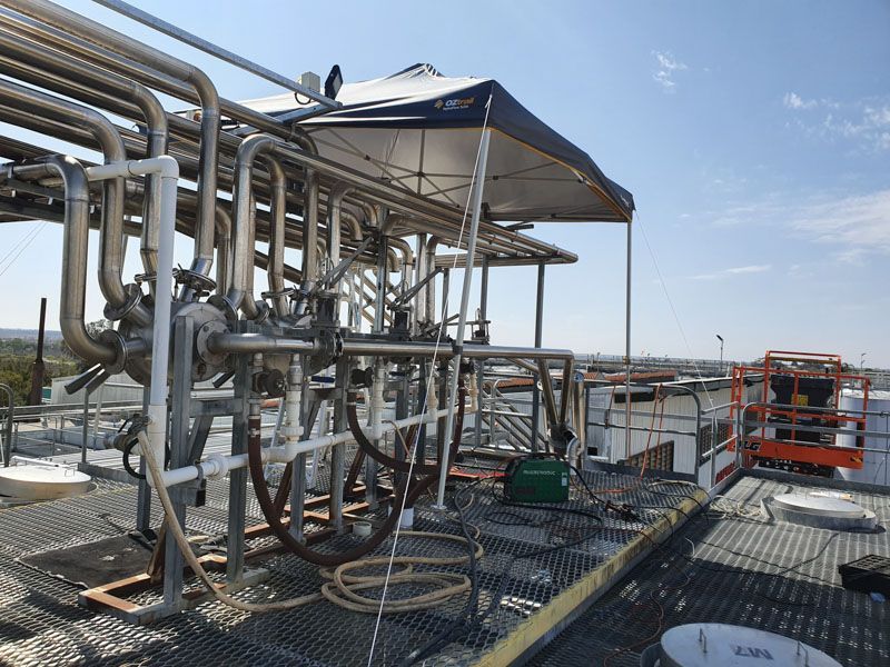 A rooftop with a lot of pipes and a canopy